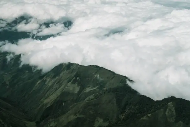 Photo of Clouds rolling over mountain peaks near Quito