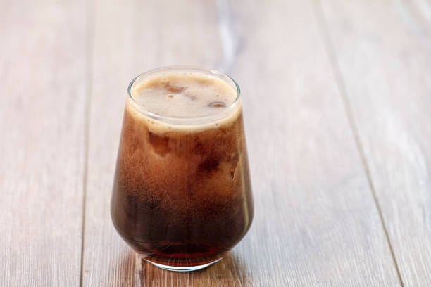 istock Soda (cola) being poured into plain glass with ice 1088357796