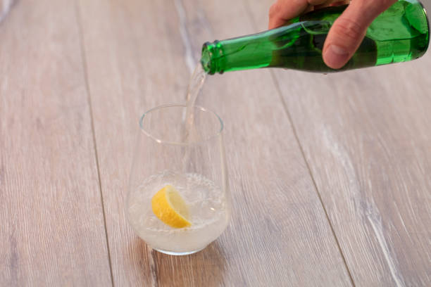 istock Soda or Water being poured into plain glass with ice 1088359068