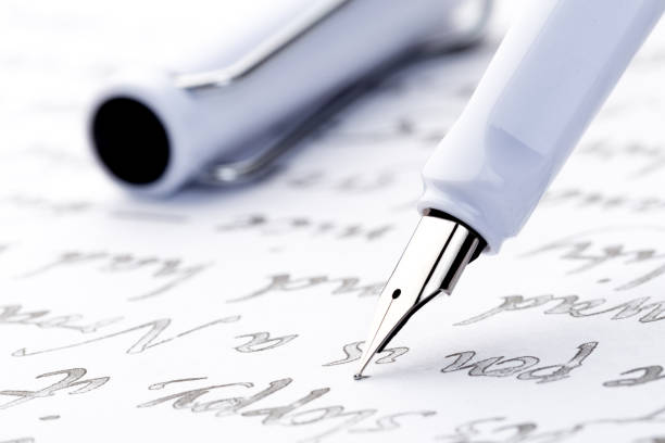 istock yellow and white fountain pens on a letter 1088359492