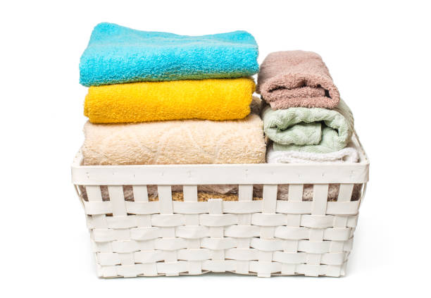 istock Clothes in a laundry wooden basket isolated on white background 1088359538