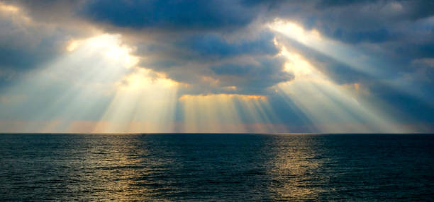 istock sun beams shining through dramatic clouds onto the sea 1088365828