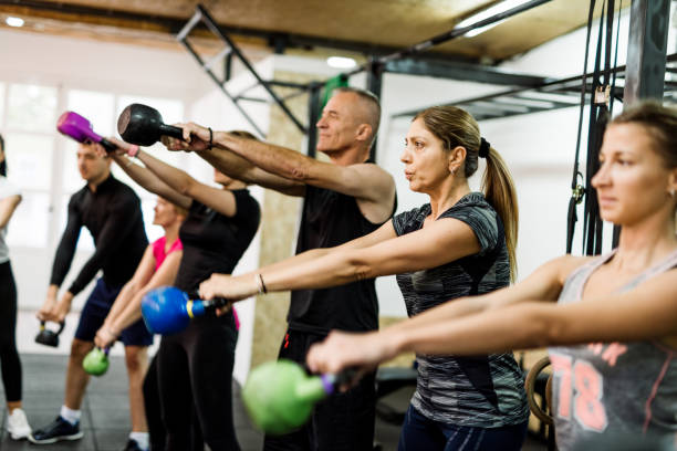 istock Exercising in team with professional fitness instructor 1088371086