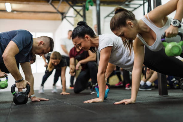 istock Exercising in team with professional fitness instructor 1088371162