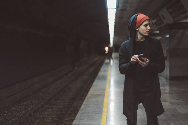 istock Young skater man using mobile phone at train station 1088371244