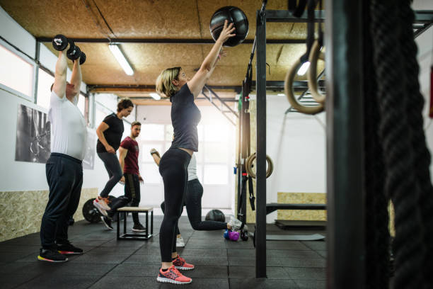 istock Exercising in team with professional fitness instructor 1088373048