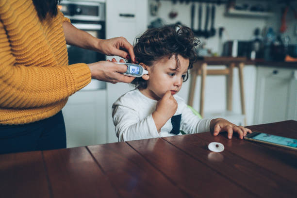 istock Measuring little boy's temperature 1088379560