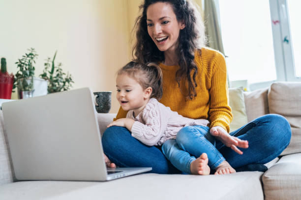 istock Mother and daughter watching cartoons 1088379590