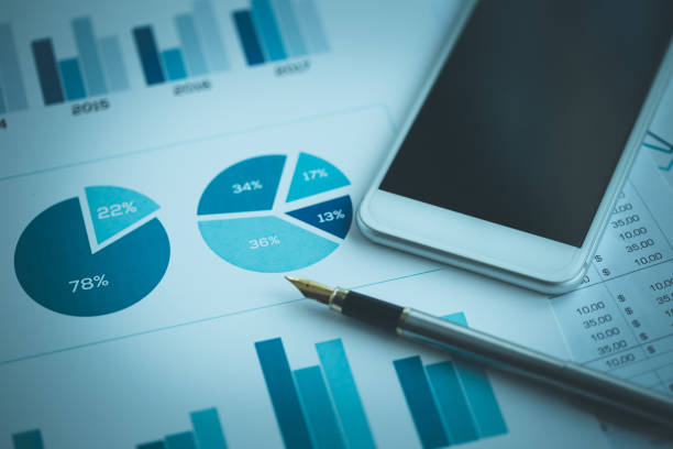 istock BUSINESS GRAPHS AND SMART PHONE CONCEPT 1088395984