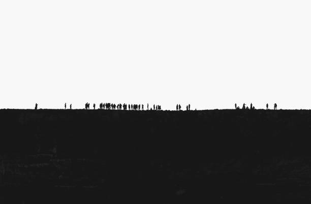 Young adults congregating on a ridge, silhouetted white