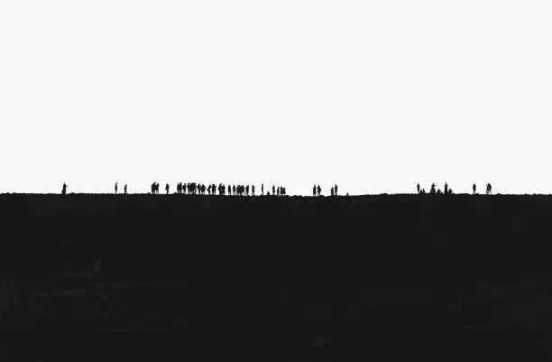 Young adults congregating on a ridge, silhouetted white