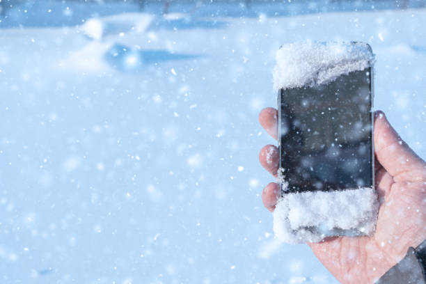 istock snowy smartphone in hand 1088406176