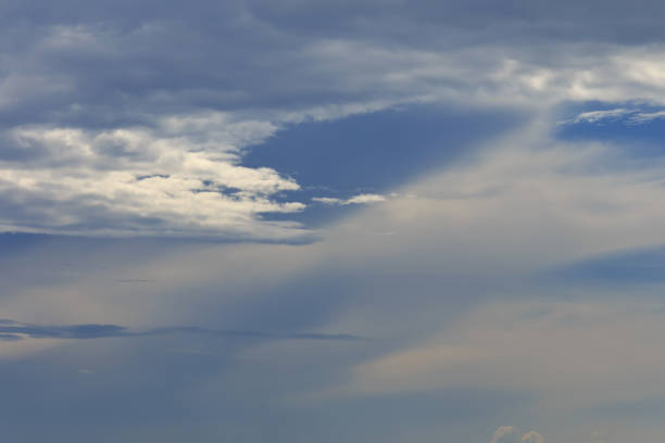 Dark sky with sun ray coming through the cloud at midsummer, Estonian sky.