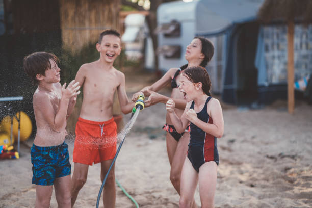 istock Friends cooling down with garden hose at the beach 1088408018