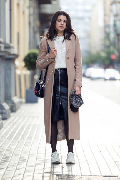 istock Pretty young woman looking at camera while posing in the street. 1088409066