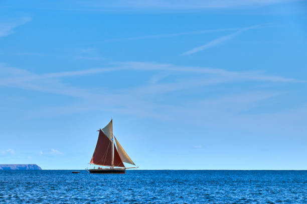 Gaff rigged sailing boat Gaff rigged traditional sailing boat sailing along the English Channel off Cornwall gaff sails stock pictures, royalty-free photos & images