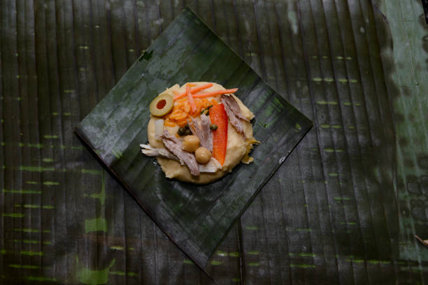 Tamales are a traditional Latin American dish.  It is prepared using corn meal along with rice, vegetables and either pork or chicken meat.  It is wrapped with banana leaves. It is a traditional food usually prepared around the Christmas holiday.