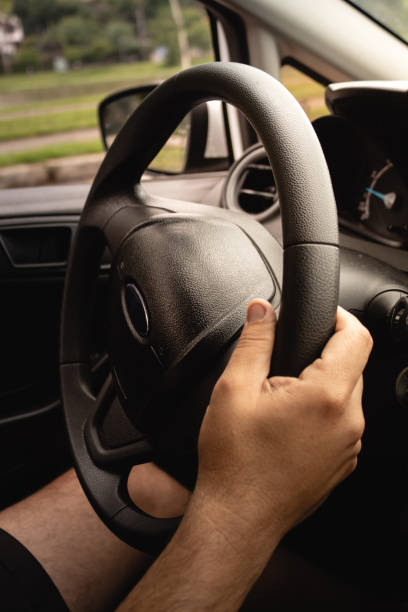 istock Close up of man's hand on steering wheel during a trip 1088420794