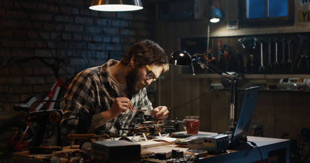 Man soldering drone in a garage
