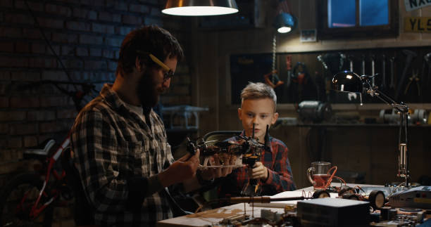 istock Father and son repairing a drone 1088420962