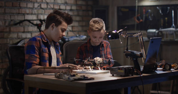 istock Two boys repairing a drone 1088421114