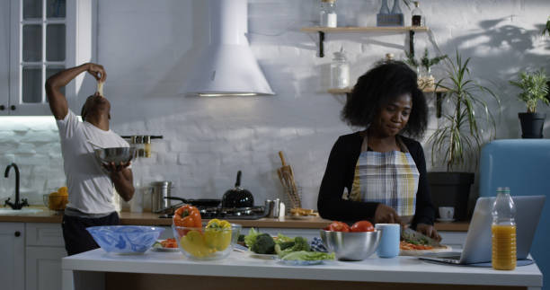 istock Young man playfully teasing wife in the kitchen 1088421290