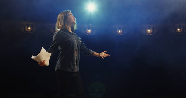 Actress rehearsing in a theater Medium close-up of an actress rehearsing a monologue in a theater while holding her script stage actress stock pictures, royalty-free photos & images