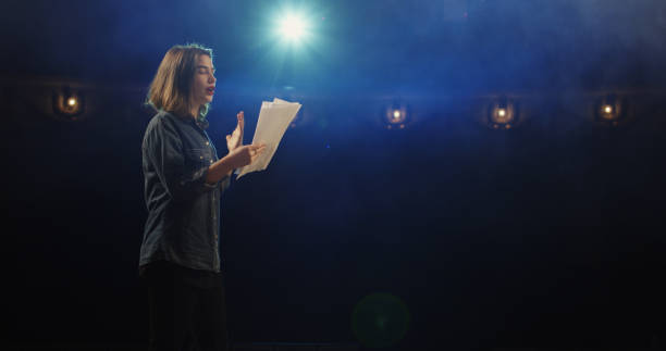 Actress rehearsing in a theater Medium close-up of an actress rehearsing a monologue in a theater while holding her script actor stock pictures, royalty-free photos & images