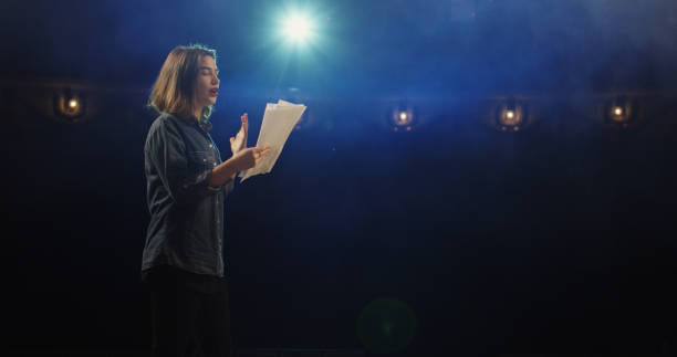 Actress rehearsing in a theater Medium close-up of an actress rehearsing a monologue in a theater while holding her script stage actress stock pictures, royalty-free photos & images