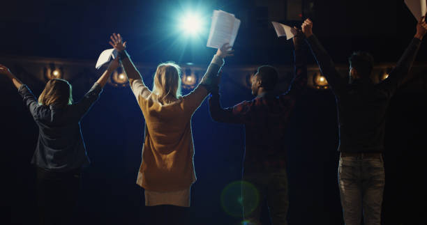 Actors bowing to audience in a theater Slow motion of actors and actresses bowing to audience in a theater stage actress stock pictures, royalty-free photos & images