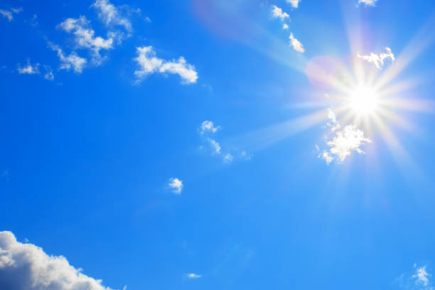istock Sun with beautiful beams in the blue sky with some clouds 1088423784
