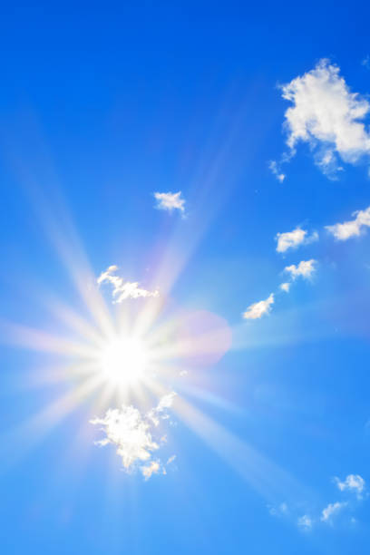 istock Sun with beautiful beams in the blue sky with some clouds 1088423796