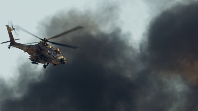 AH-64D Apache Longbow military helicopter attacking targets with canon