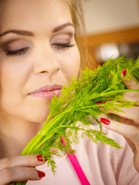 istock Young woman holding dill herb 1088427684