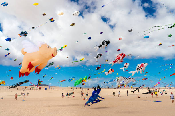 Colorful kites against a blue sky stock photo