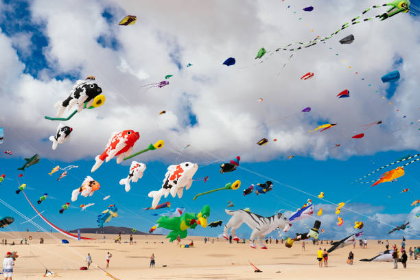 Colorful kites against a blue sky stock photo