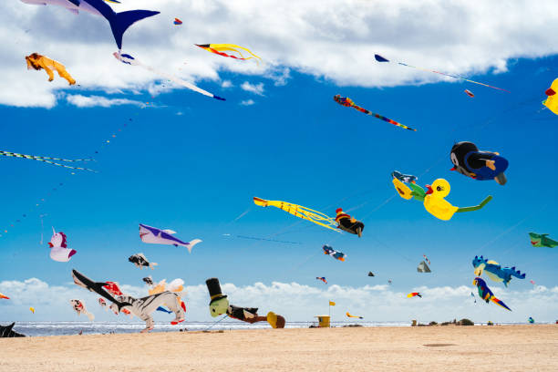 Colorful kites against a blue sky stock photo