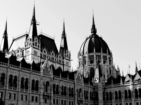 Exterior detail of the Hungarian Parliament & main dome in Budapest. The city is a popular European travel destination with many landmarks & attractions. The parliament is a main tourist attraction in the city.