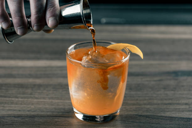 istock bartender barmen with cocktail preparing orange cocktail at bar. alcohol drinks 1088441382