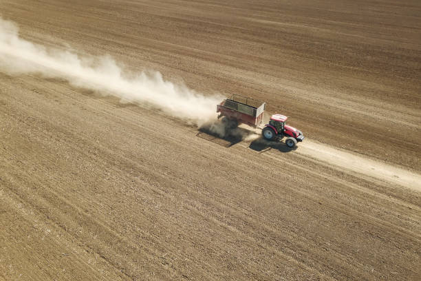 istock Tractor going trough agriculture field Aerial view 1088445846