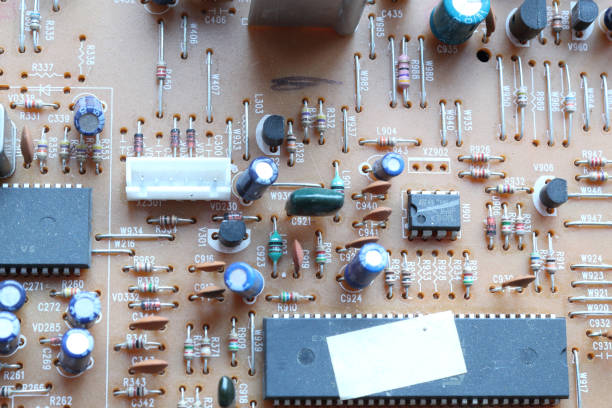 istock A light brown printed circuit board with through hole resistors, capacitors and microchips electronic components, seen on top side, with silk screen 1088453238