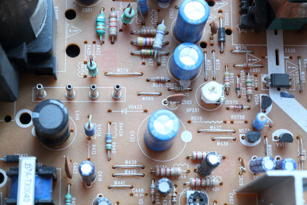 istock A light brown printed circuit board with through hole resistors, capacitors and microchips electronic components, seen on top side, with silk screen 1088454136