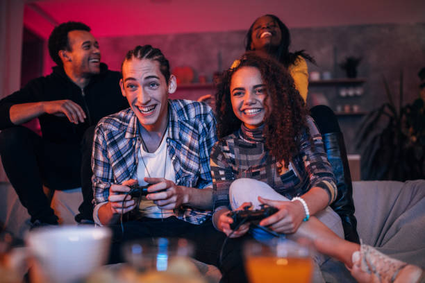 istock Young friends playing video games 1088467016