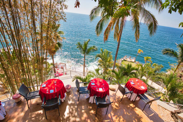 Puerto Vallarta, romantic upscale restaurant overlooking scenic ocean landscapes near Bay of Banderas Puerto Vallarta, romantic upscale restaurant overlooking scenic ocean landscapes near Bay of Banderas adobe material photos stock pictures, royalty-free photos & images