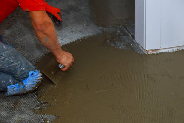 istock Troweling mortar onto a concrete floor in preparation for floor tile. 1088481604