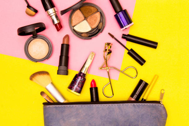 istock Make up bag with cosmetics on yellow and pink background. 1088483094