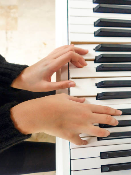 istock young lady playing the piano 1088488502