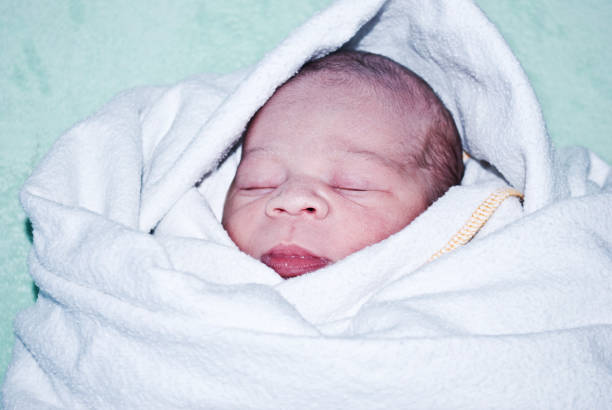 istock New-born baby wrapped in blanket 1088492428