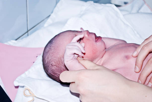 istock New-born baby undergoing first medical examination 1088495238