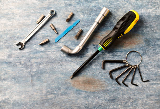 istock Screwdriver, hex keys, socket wrench and bits for a screwdriver on rustic wooden background. copy space. 1088509530